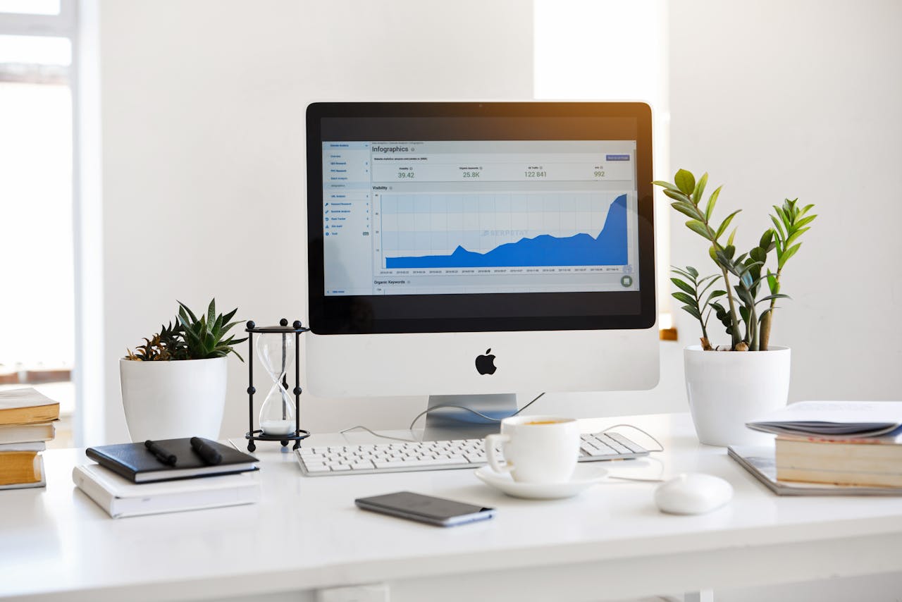services-01 A clean, contemporary workspace featuring a desktop with analytics on the screen and plants for a fresh look.
